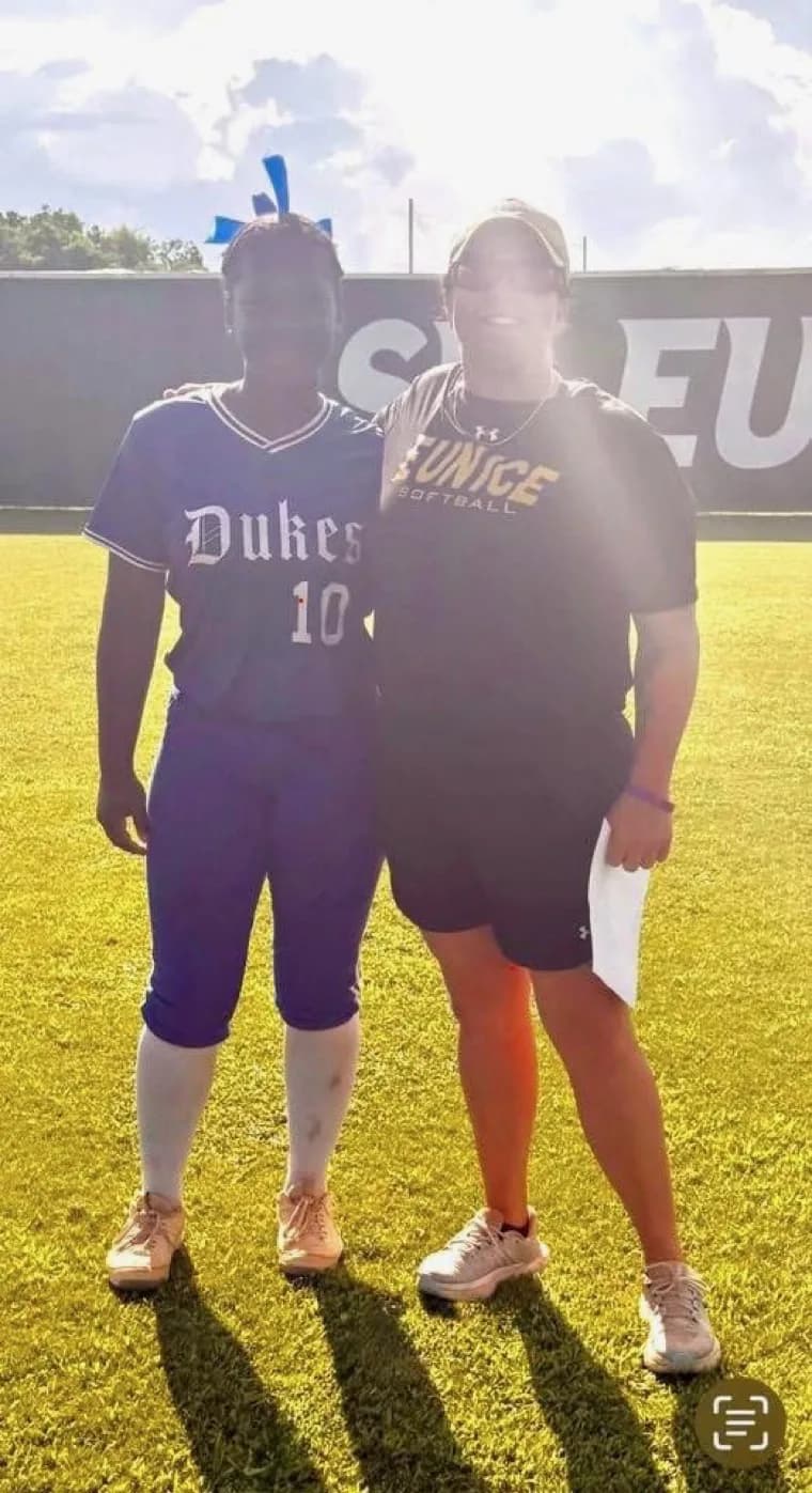 Kennedi Fair with a LSU Eunice softball coach at a camp.