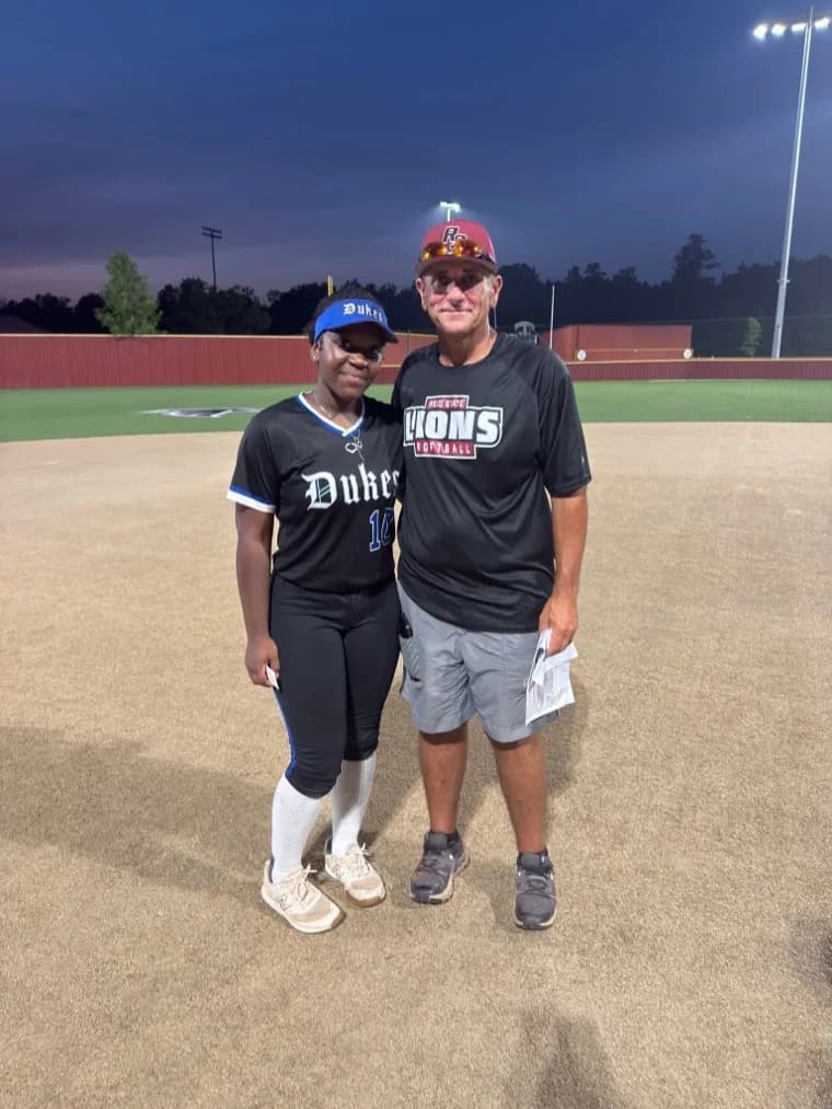 Kennedi Fair with a Reid State softball coach at a camp.