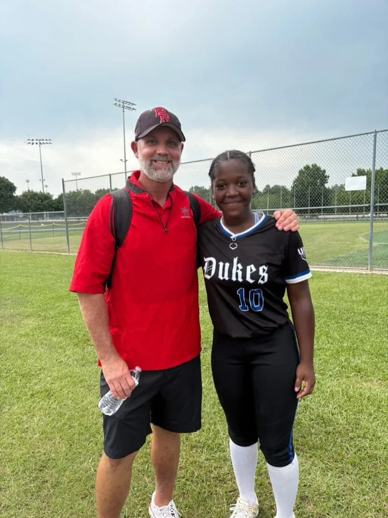 Kennedi Fair with a Baton Rouge CC softball coach at a camp.
