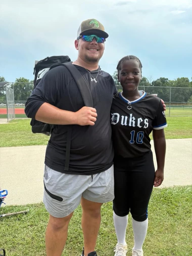 Kennedi Fair with a Meridian Community College softball coach at a camp.